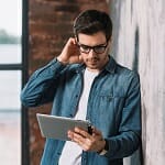 Young man looking down at his ipad