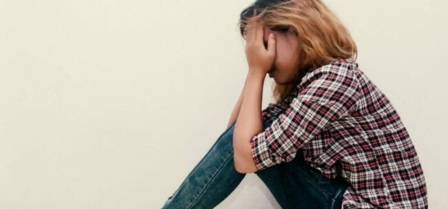 young hipster woman, sad, long-haired sitting hugging legs. young hipster woman, sad, long-haired sitting hugging legs.