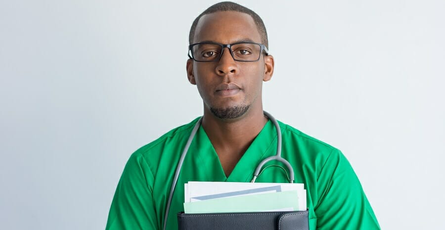 Close-up of serious young African American doctor with folder