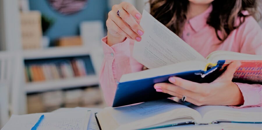 woman flipping through a textbook