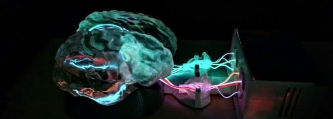 3D brain plugged into machine