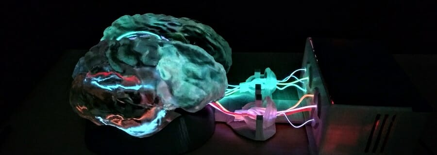 3D brain plugged into machine