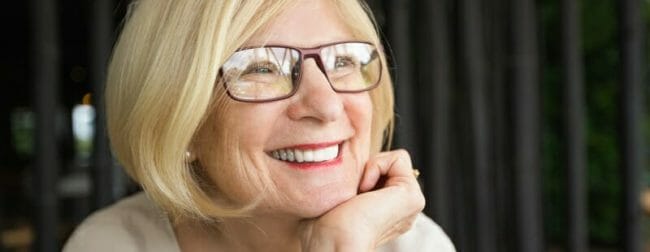 Closeup of Happy Attractive Senior Woman in Cafe