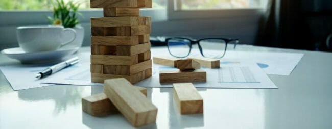 Desk with wooden blocks among loose business documents