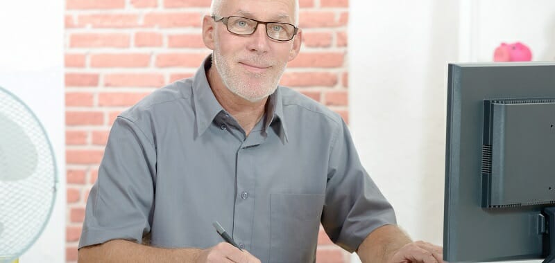 Senior businessman working on computer