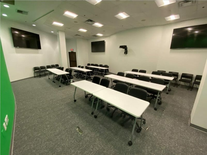 Empty classroom with rows of table and chairs inside Bartlett-Flex building
