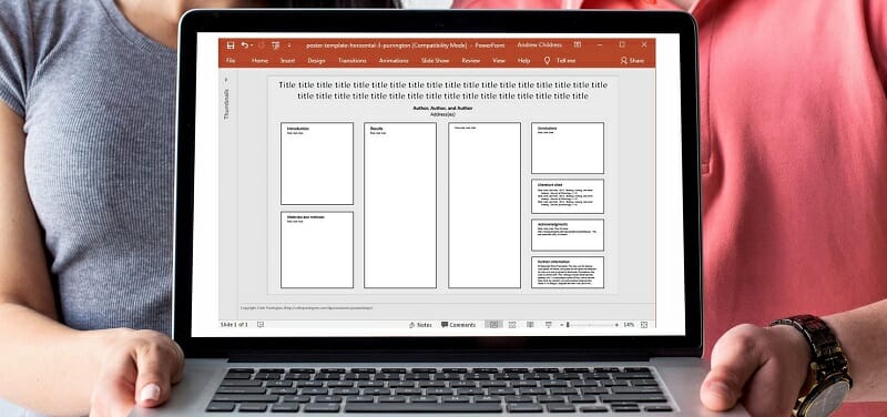 Two people holding a laptop with an organizational chart displayed on screen