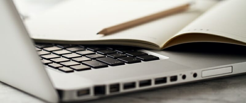 Closeup of Workspace with Modern Creative Laptop, Cup of Coffee