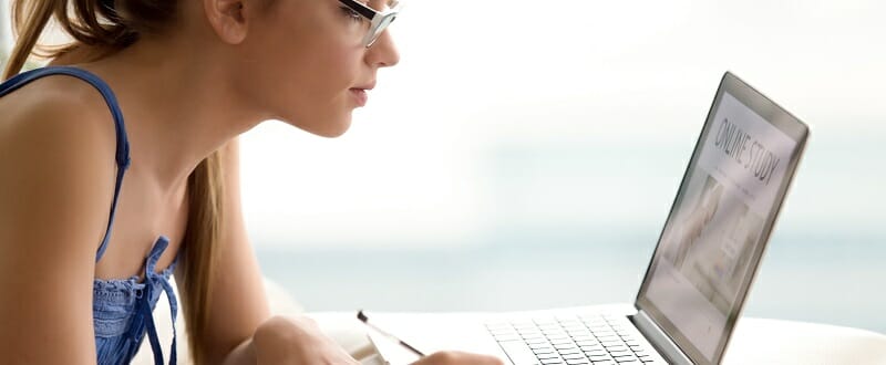 Female student studying online with laptop