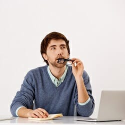 Thoughtful businessman sitting at the office desk